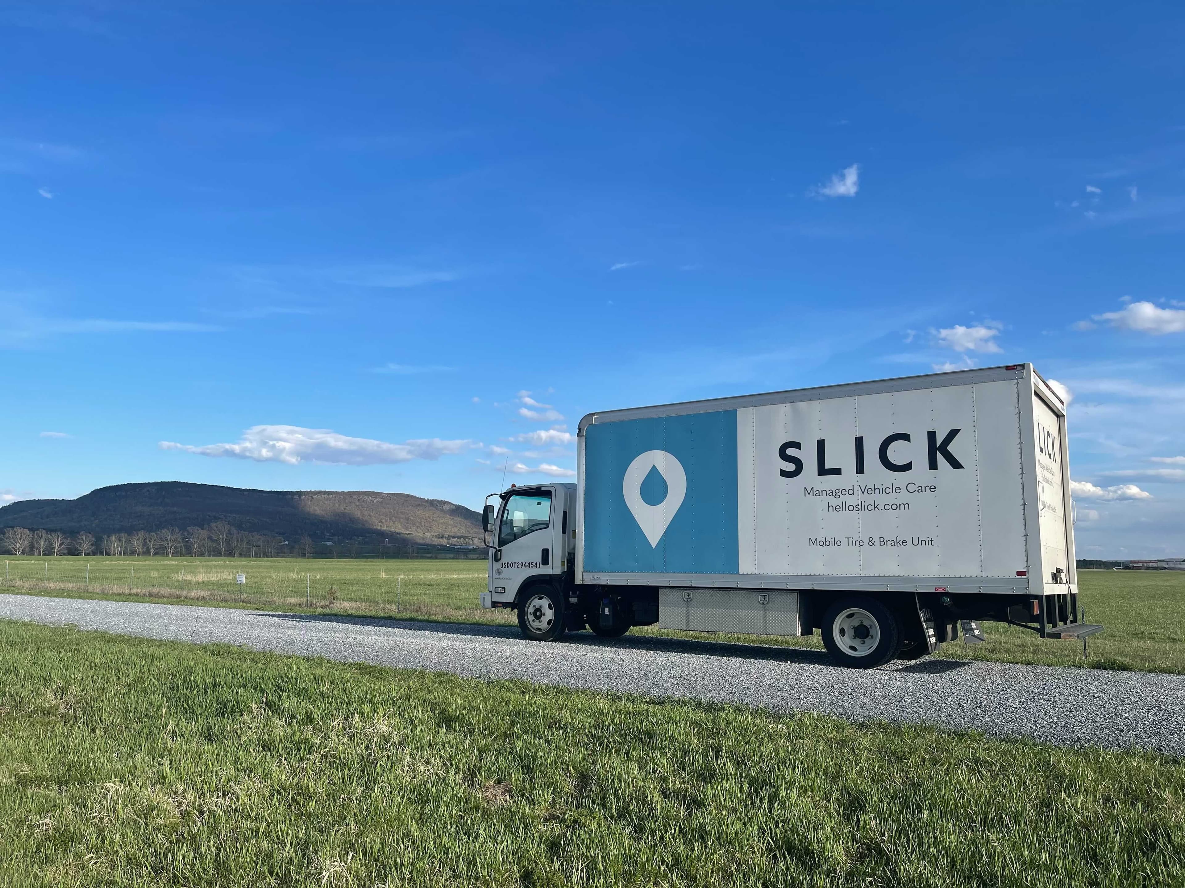 Fleet vehicles being serviced on site by Slick technicians