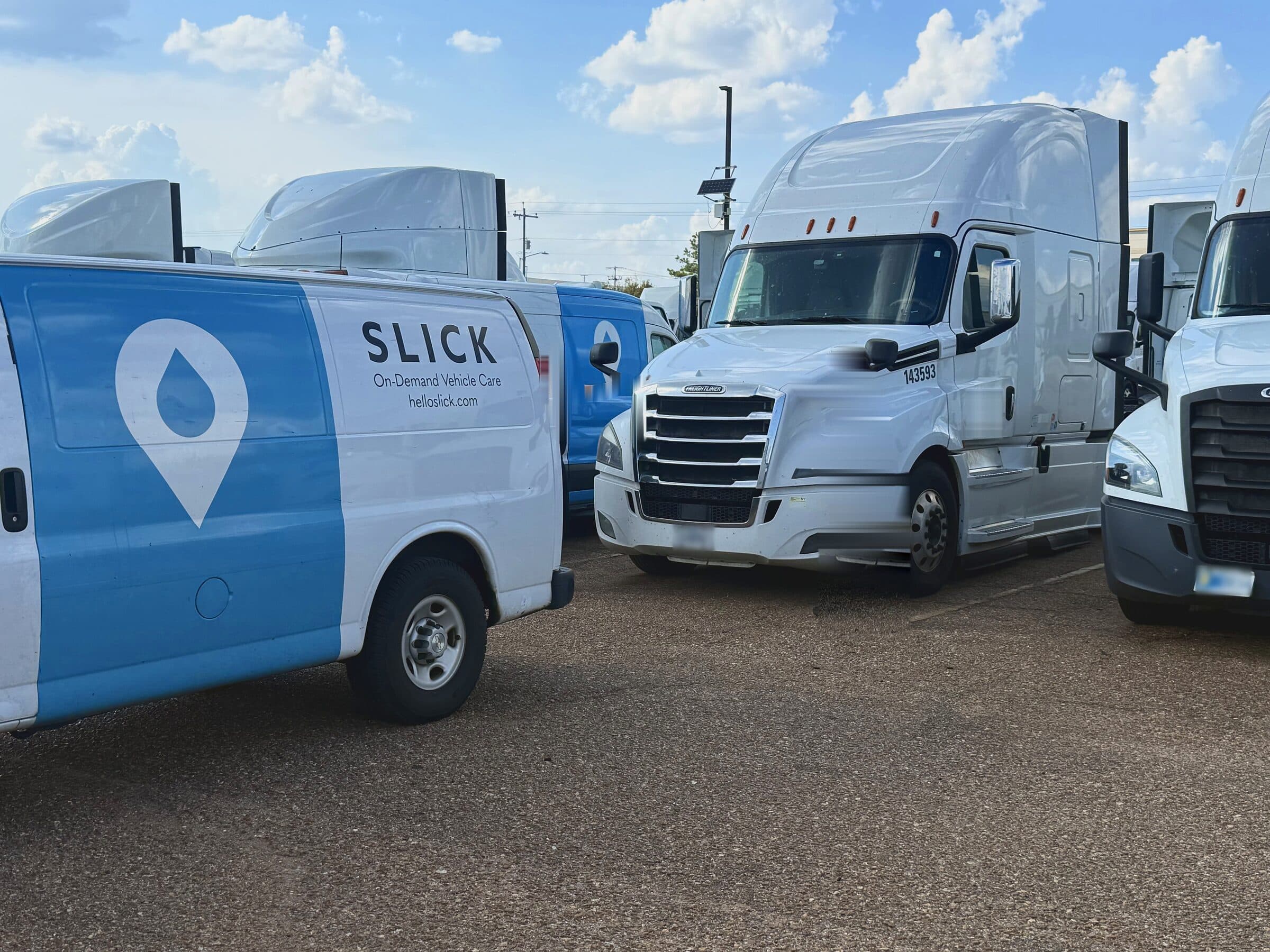 Slick service van on a customer yard beside a row of Class 8 tractors on a recurring Dry inspection route