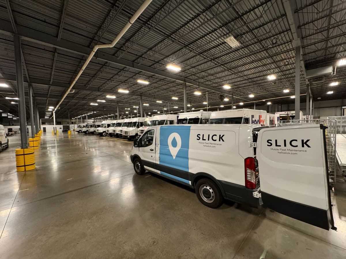 Slick service van parked on a customer yard for a scheduled maintenance visit