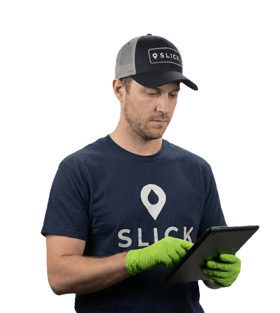 Slick technician documenting fleet inspection on tablet